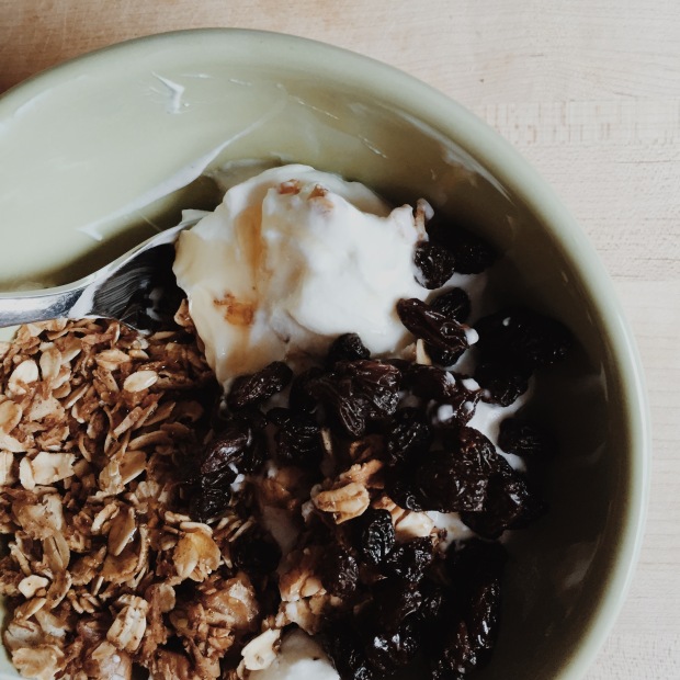 breakfast: granola with yogurt, honey drizzle and raisins.